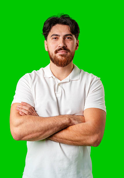 istock A man with a serious expression stands against a vibrant green background 2226259718