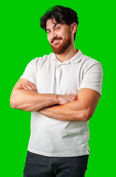 A young man with a beard showing a serious expression against a vibrant green background