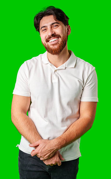 istock A man with a beard smiles confidently against a bright green background 2226260008