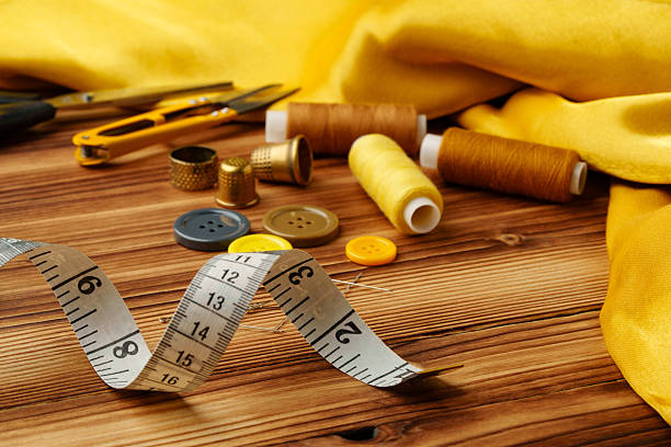 Crafting tools and materials arranged on a wooden table ready for sewing and creative projects close up