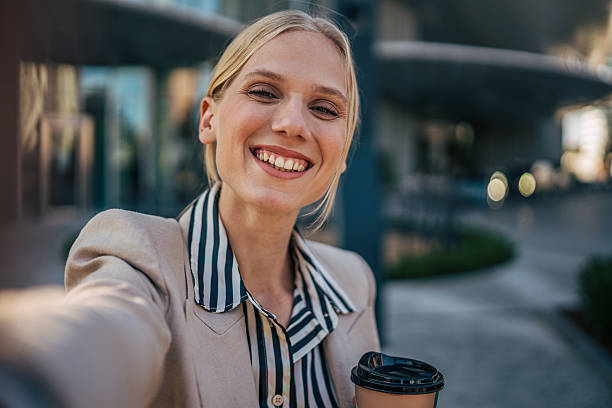 istock Smiling businesswoman taking a selfie while holding coffee 2226262732