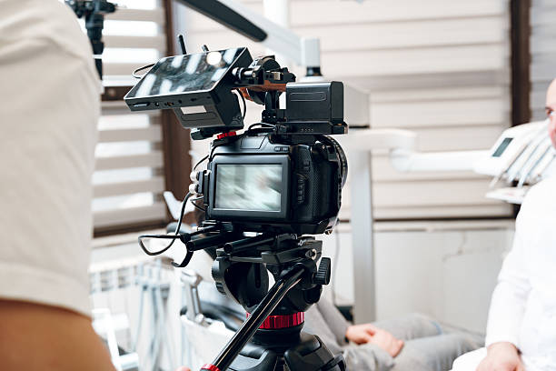 istock A person operates a handheld gimbal stabilizer with a camera in a modern studio setting during a daytime shoot 2226264451