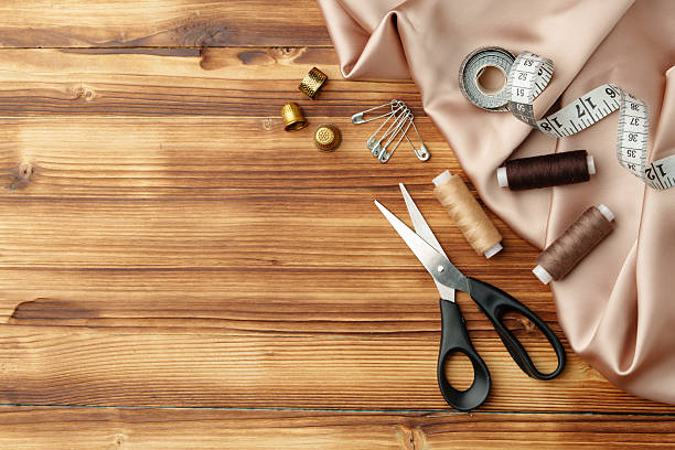 istock Crafting tools and materials arranged on a wooden table for sewing projects 2226264529
