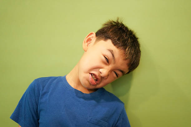 Close-up face boy frowned on green wall