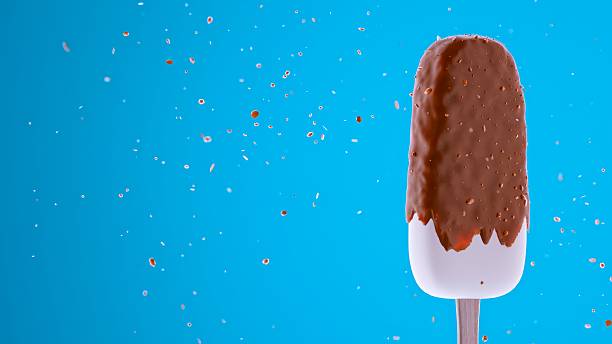 istock Chocolate-dipped ice cream bar with white base and scattered particles 2226266704
