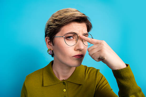 istock Confident young woman wearing khaki shirt and glasses gesturing with a curious expression against a bright blue background 2226268207
