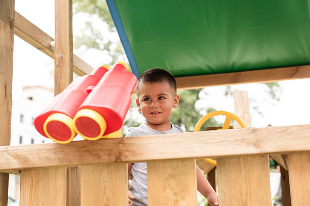 istock Curious boy playing with binoculars in playground house 2226268342