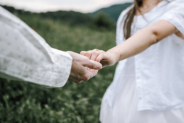 istock Close up Of Two Young People Holding hands 2226269022