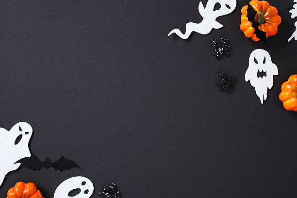 istock Happy Halloween flat lay composition with ghosts, buts, spiders, pumpkins on black background. Top view with copy space. 2226272305