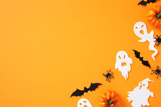 istock Happy Halloween flat lay composition with ghosts, spiders, bats, pumpkins on orange background. Top view with copy space 2226272337