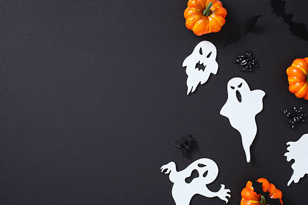 istock Happy Halloween flat lay with pumpkins, ghosts, bats, and spiders on dark background with copy space for text 2226272344