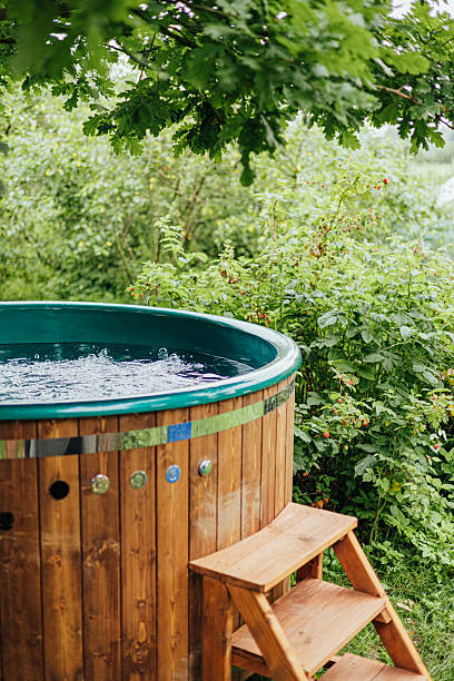 istock Wooden Hot Tub Under Tree in Bubbling Spa Garden 2226272395