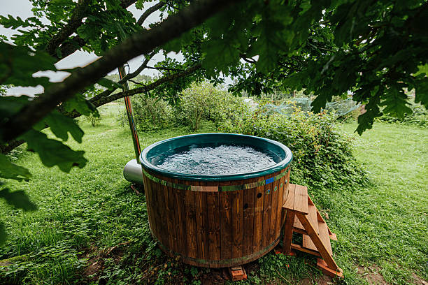 istock Wooden Hot Tub Under Tree in Bubbling Spa Garden 2226272398