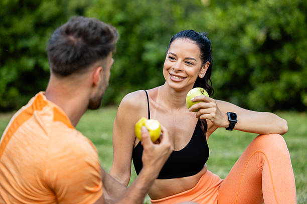 istock Fitness people eating apple fruit after training outdoors. Healthy lifestyle. 2226272647