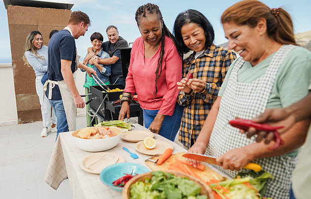 istock Multi generational people doing barbecue at home's rooftop - Multiracial friends having fun eating and cooking together during weekend day - Summer and food concept - Main focus on man with red hair 2226272823