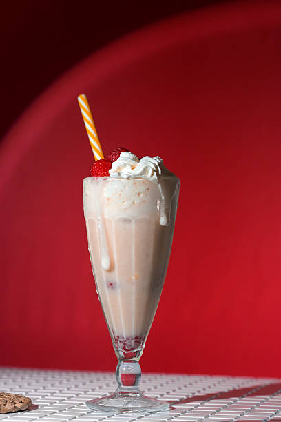 istock Milkshake with berry topping and foam on red background 2226274485