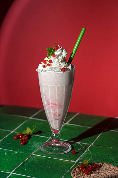 istock Milkshake with berry topping and foam on red background 2226274490