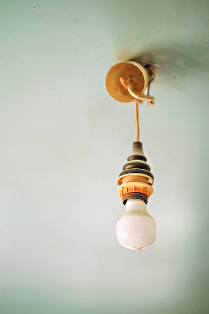 istock Vintage hanging light bulb over gray background 2226274950