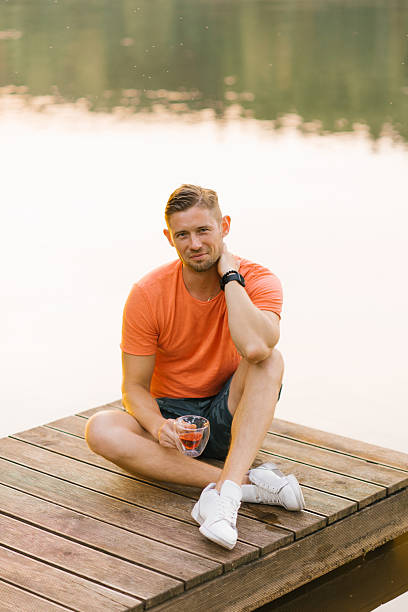 istock Smiling Man Relaxing On Wooden Pier 2226274962