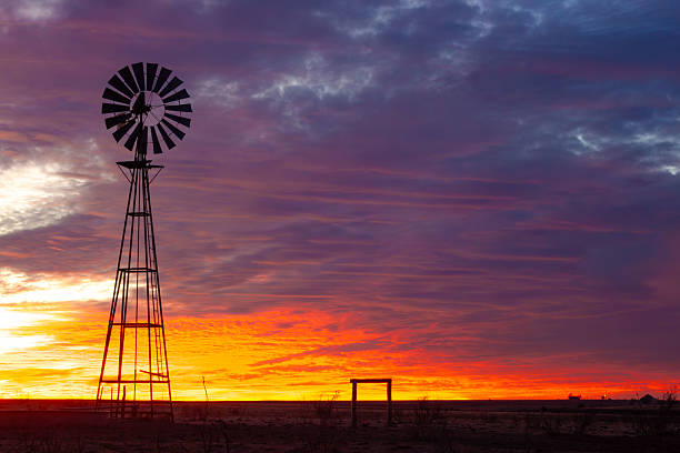 istock Windmill Against Purple and Orange Sunset on the Plains 2226275980