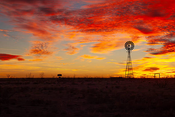 istock Windmill Silhouette at Fiery Texas Sunset 2226275983