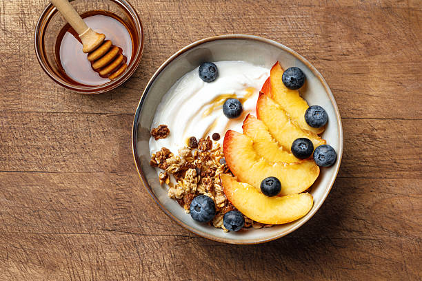 istock Granola bowl with yogurt, peach, blueberries and honey 2226276027
