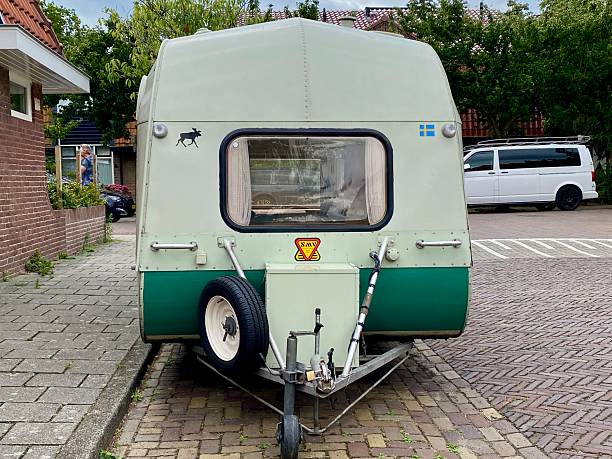 Santpoort,  Netherlands - July 21, 2025.  Retro Mobile Home parked  in the narrow city Street.