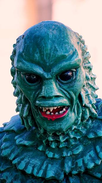 Green, scary Halloween monster statue baring its teeth and exuding a threatening aura, embodying the spirit of the spooky season with a chilling presence perfect for celebrations