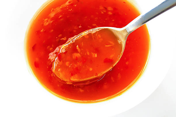 istock Sweet chilli sauce on spoon in a white bowl. 2226276932