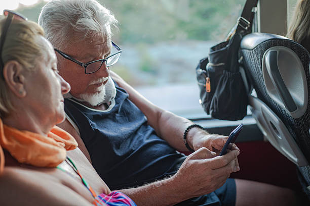 istock Elderly couple riding a bus and using a mobile phone 2226279501