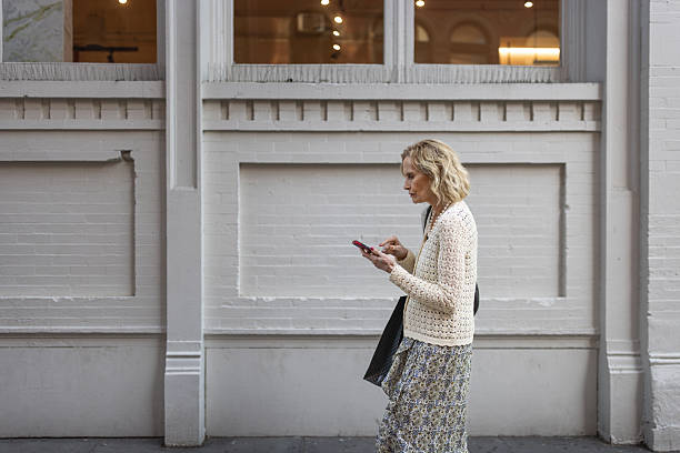 istock Stylish Woman Walking and Texting 2226282426