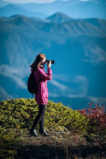 istock Woman photographing mountain landscape 2226284524