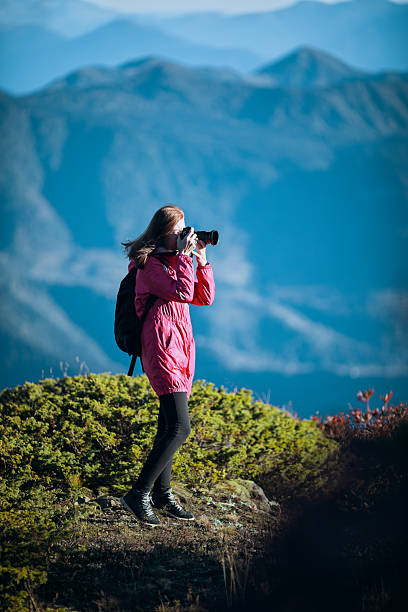 istock Woman photographing mountain landscape 2226284526