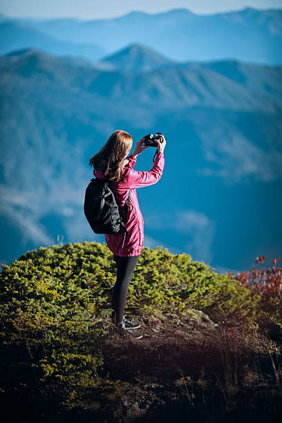 istock Woman photographing mountain landscape 2226284537
