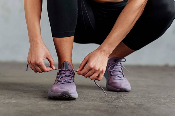 istock Focused Athlete Tying Purple Running Shoes 2226285706