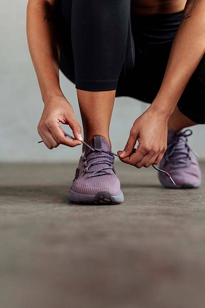istock Fit Woman Tying Sneakers Before Workout 2226285713