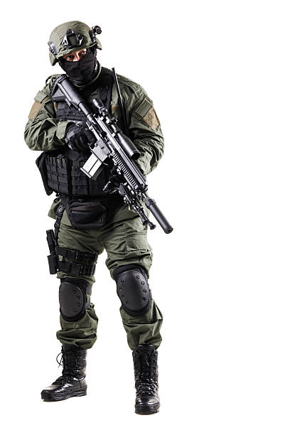 istock Armed tactical officer in protective gear holding firearm during operation 2226286852