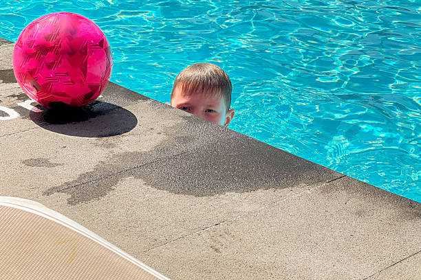 istock Boy looking out of the pool 2226288938