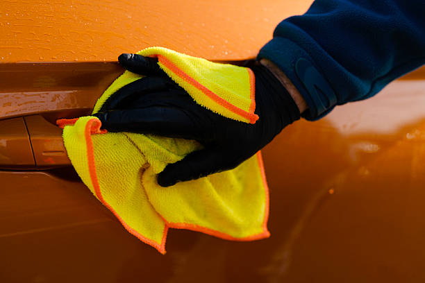 istock Cleaning and polishing orange car with  microfiber towel 2226290546