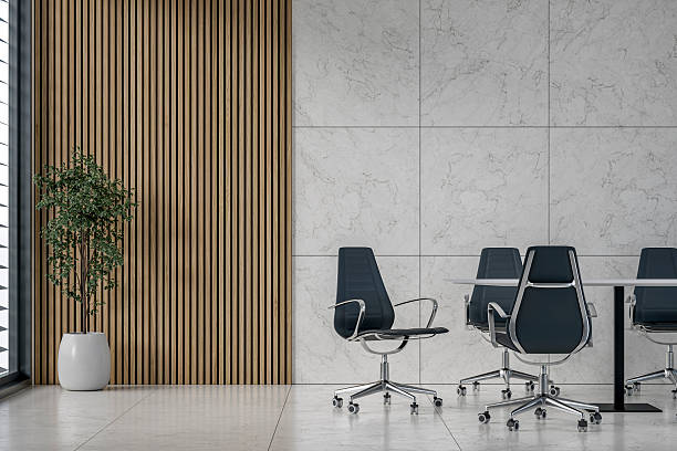 istock A modern office interior with conference table, chairs on marble tiled floor, window and decoration in front of half marble half hardwood slats 2226293782