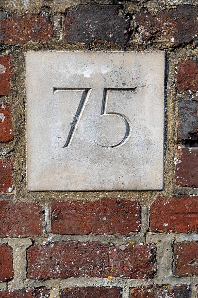 istock Number seventy five in elegant carved figures on exterior wall 2226296462