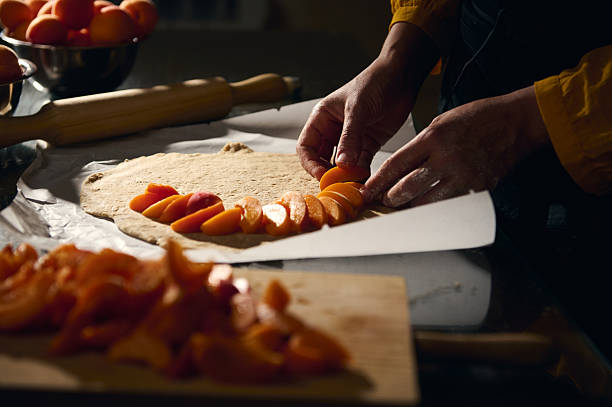 istock Preparing a Homemade Apricot Pastry With Fresh Fruit and Rustic Techniques 2226296817