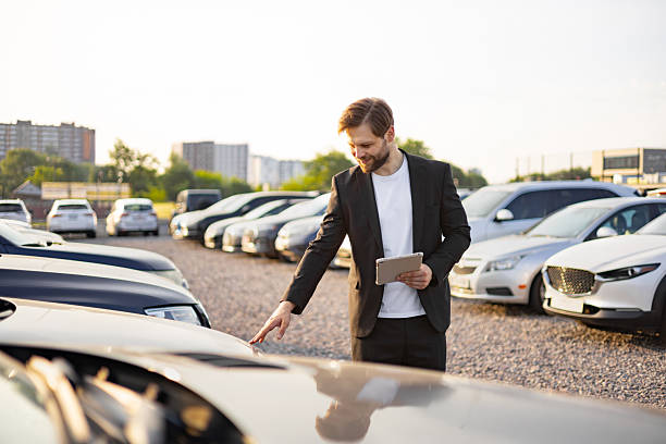 istock Car Salesman Inspecting a Vehicle 2226297915
