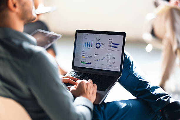 istock Person Analyzing Business Metrics on Laptop in Office Environment 2226298646