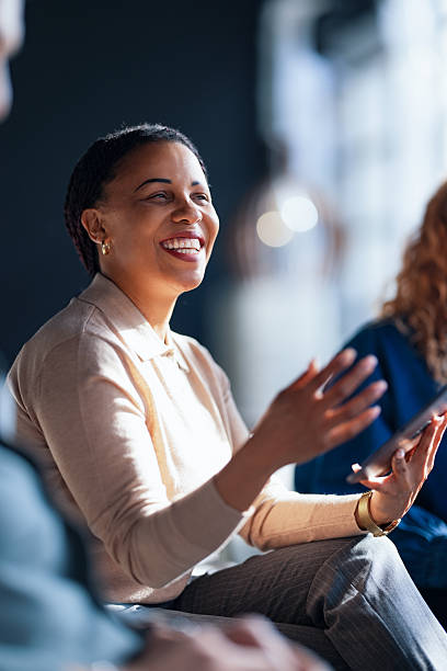 Smiling Professional Engaged in a Collaborative Work Discussion in a Bright Office