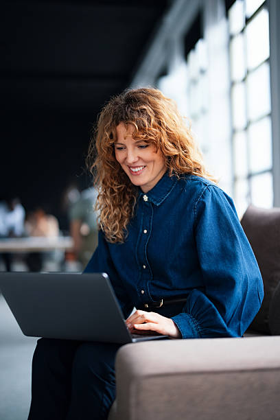 istock Smiling Professional Woman Using Laptop in Modern Office Environment 2226298711