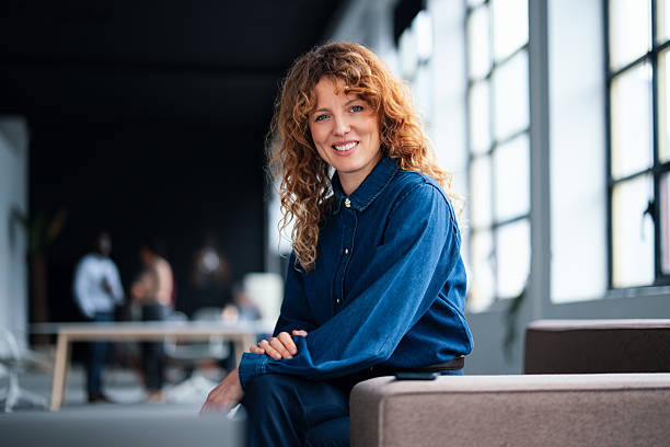 istock Confident Woman Sitting in Modern Office Workspace with a Warm Smile 2226298714