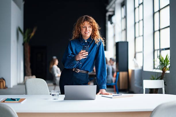 istock Professional Woman Using Smartphone in Modern Office Workspace 2226298720