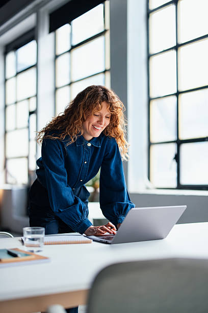 istock Professional Woman Engaging with a Laptop in a Bright Office Environment 2226298731
