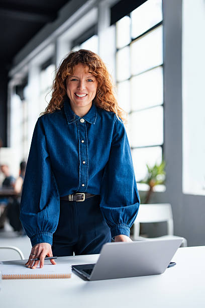 istock Businesswoman in Modern Office Environment Working with Laptop and Notebook 2226298737